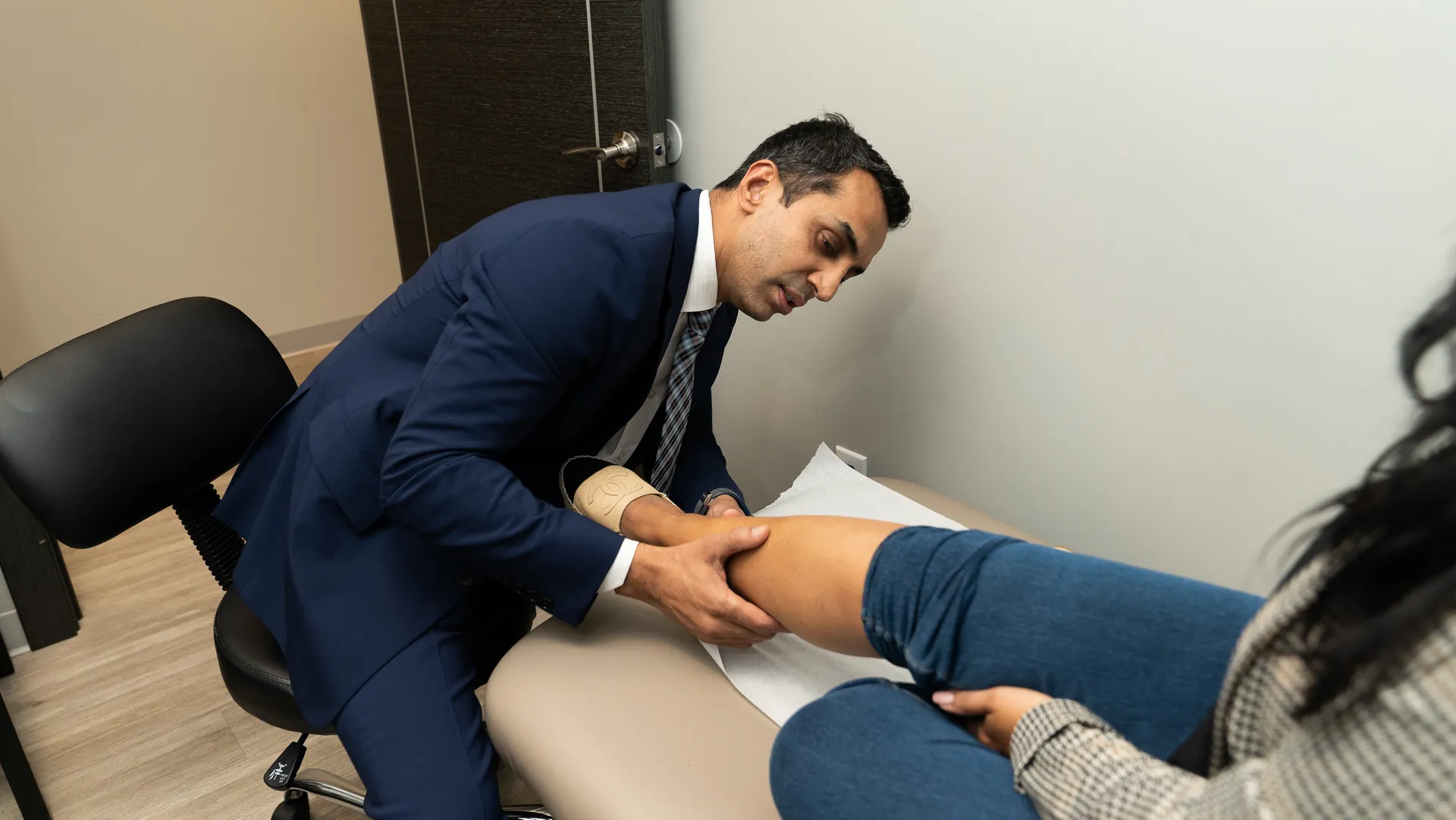 Dr. Sood examining a patient
